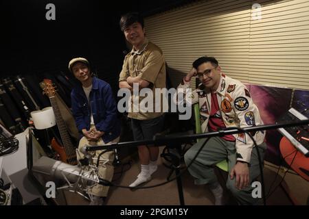 Rubberband with (L to R) bassist Lee Siu-wai, drummer Lai Man-wang, and singer Mau Hou-cheong, at their studio in Kowloon Bay.  07MAR23 SCMP / Jonathan Wong Stock Photo