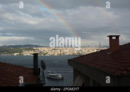 Looking at a rainbow across the Strait of Bosphorus from Cihangir, Beyoglu on the European side to Uskudar on the Asian side of Istanbul, Turkey. Stock Photo