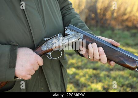 A close up of a man shooting game in the countryside Stock Photo