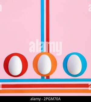 Creative concept of Easter eggs on pink background with colored paper. 70 style art. Flat lay. Stock Photo