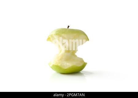 Tasty half eaten green apple reflected on white table and white isolated background. Front view. Stock Photo