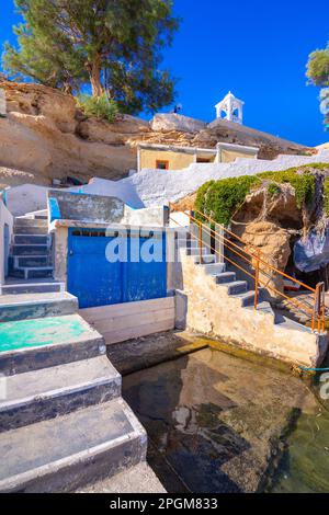 Scenic Mandrakia village (traditional Greek village by the sea, the Cycladic-style) with sirmata - traditional fishermen's houses, Milos island, Cycla Stock Photo