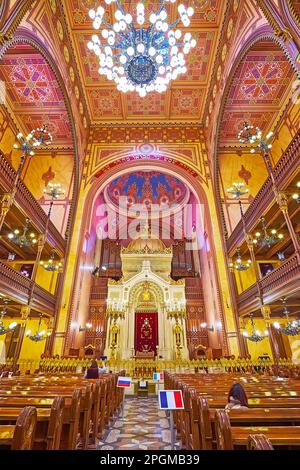 BUDAPEST, HUNGARY - FEB 22, 2022: Interior of Dohany Street Synagogue with carved Torah Ark and richly decorated ceiling with painted geometric patter Stock Photo