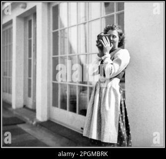 Eva Braun, mistress (later wife) of Adolf Hitler, standing on terrace in typical Bavarian dress, taking a photograph with her box camera, at The Berghof, Berchtesgaden, Bavaria Nazi Germany, 1930s, wife, & past mistress of Adolf Hitler - From The Eva Braun Photo Albums Stock Photo