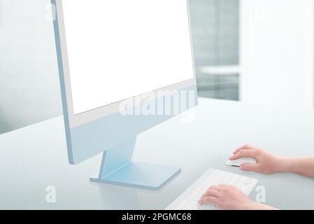 Work on computer with isoalted screen for design presentation, mockup. Hands hold the mouse and type on the keyboard. Clean office desk. Close-up Stock Photo