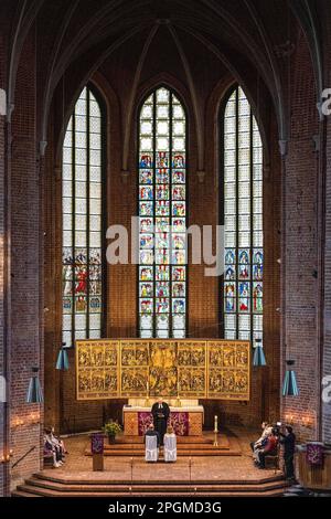 Hanover, Germany. 23rd Mar, 2023. Pastor Stephan Lackner (M) marries Anne-Marie (r) and Michael Kendelbacher in the Marktkirche. The 23.3.23 is a special wedding date: On this day, 16 couples give their wedding vows in the romantic candlelit Marktkirche from 17-24 o'clock. Credit: Sina Schuldt/dpa/Alamy Live News Stock Photo