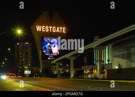 A picture of the Westgate Las Vegas Resort and Casino billboard next to the Las Vegas Monorail at night. Stock Photo