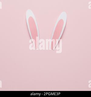 Rabbit or bunny paper ears on pink background. Minimal Easter concept. Stock Photo