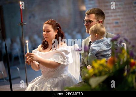 Hanover, Germany. 23rd Mar, 2023. Jacqueline (l) and Marvin Cabeza get married in the Marktkirche. The 23.3.23 is a special wedding date: On this day, 16 couples give their wedding vows in the romantic candlelit Marktkirche in the time from 17-24 o'clock. Credit: Sina Schuldt/dpa/Alamy Live News Stock Photo