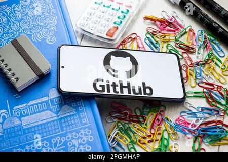 In this photo illustration a GitHub logo seen displayed on a smartphone. Stock Photo