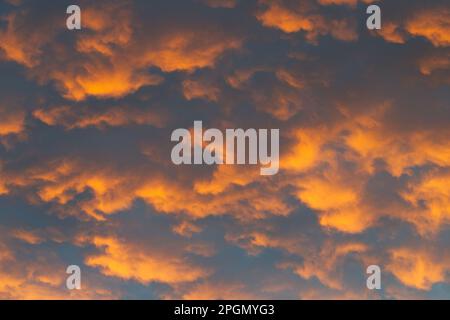 Orange abstract background sky with clouds patterns in late afternoon light, Victoria, Australia. Stock Photo