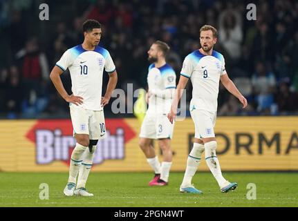 England's Jude Bellingham (left) and Harry Kane appear dejected after Italy's Mateo Retegui scores their first goal during the UEFA Euro 2024 qualifying match at the Diego Armando Maradona Stadium in Naples, Italy. Picture date: Thursday March 23, 2023. Stock Photo