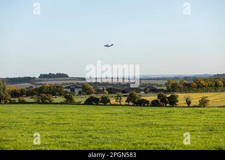 A Royal Air Force Lockheed C-130J Hercules military transport plane, Serial No. ZH872, flies above the Salisbury Plain Training Area in Wiltshire, Stock Photo