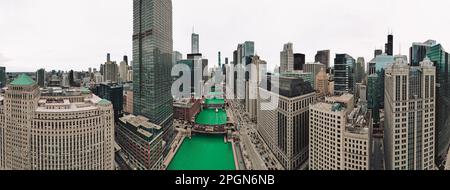 A stunning aerial view of the Chicago cityscape with glistening Chicago river, soaring skyscrapers, and lush green areas Stock Photo