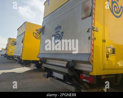 Merida, Spain - February 20th, 2023: Correos trucks fleet parked outdoors. State-owned company responsible for providing postal service in Spain Stock Photo