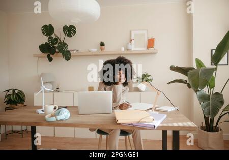 Young businesswoman taking notes in office Stock Photo