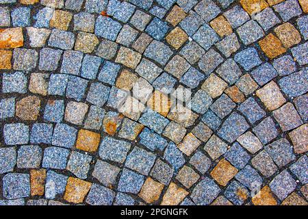 Background of stone pavement. Pavement made of grit stone blocks. Stock Photo