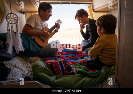 Son and parents enjoying in motor home on vacation Stock Photo