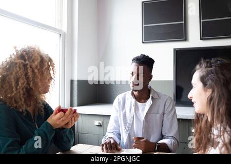 Businesswoman discussing plans with colleagues in office Stock Photo