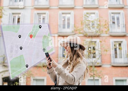 Woman navigating location with smart phone in front of building Stock Photo