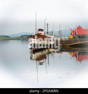 Argyll Scotland. Seagoing Paddle Steamer Waverley moored in Oban Harbour with town and fishing boats Stock Photo