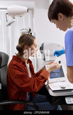 Doctor discussing with patient looking at medical results in clinic Stock Photo