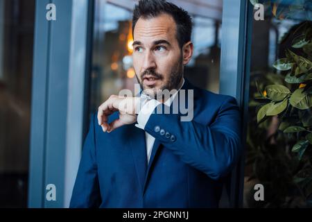 Businessman talking on smart watch Stock Photo
