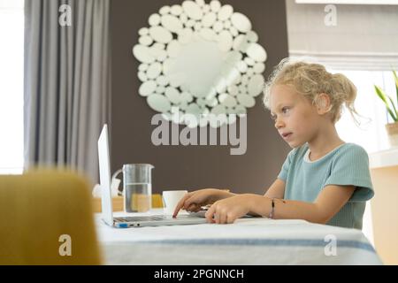Girl using laptop at home Stock Photo