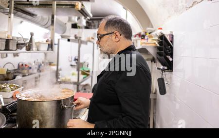 Chef preparing food at restaurant Stock Photo