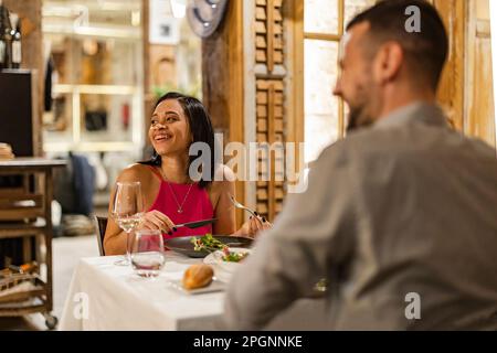 Happy couple enjoying dinner date at restaurant Stock Photo