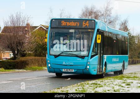 Shawbury, UK - March 10, 2023; Pale blue Arriva rural bus passing through Shawbury on route 64 to Shrewsbury on a scheduled service Stock Photo
