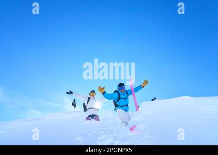 Happy mature couple enjoying in snow on sunny day Stock Photo