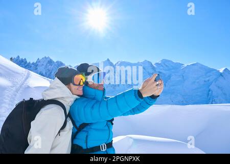 Happy mature couple taking selfie through mobile phone Stock Photo