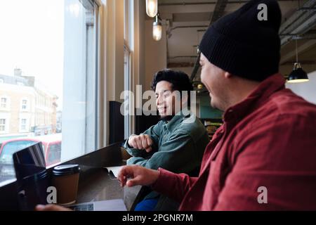 Freelancers working together in cafe Stock Photo