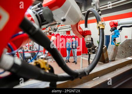 Technicians using tablet PC standing in industry Stock Photo