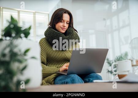 Freelancer using laptop at home Stock Photo