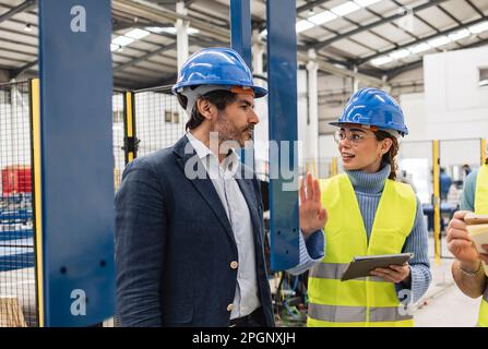Engineers having discussion in factory Stock Photo