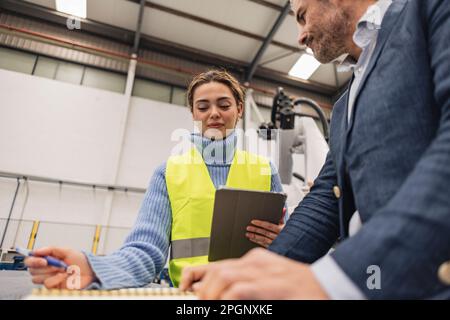 Engineers having discussion in factory Stock Photo