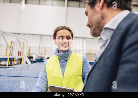 Smiling engineer with colleague working in office Stock Photo