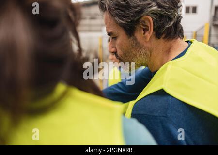 Engineers in reflective clothing working at factory Stock Photo