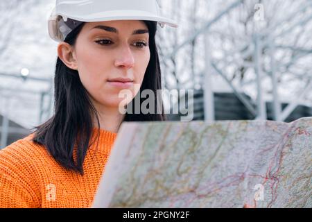 Young woman examining map at site Stock Photo
