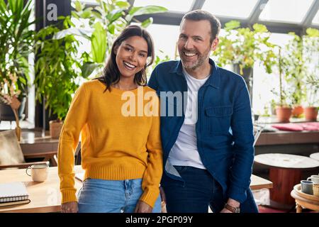 Diverse business colleagues standing together at loft office Stock Photo