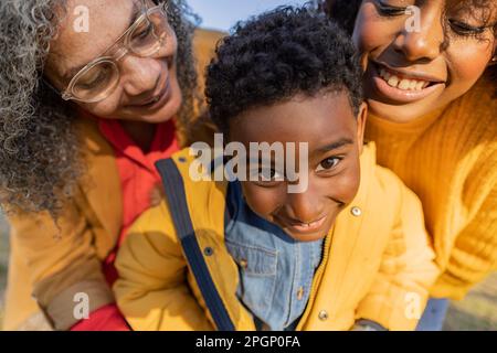 Happy multi-generation family standing together in park Stock Photo