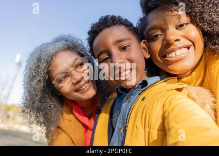 Happy multi-generation family having fun in park Stock Photo