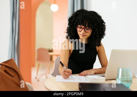 Young businesswoman with Afro hairstyle working in office Stock Photo