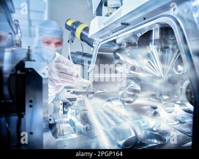 Technician scanning electron microscopes in laboratory Stock Photo