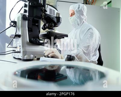 Scientist using microscope in laboratory Stock Photo