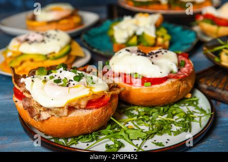 Plates with tasty eggs Benedict on table, closeup Stock Photo