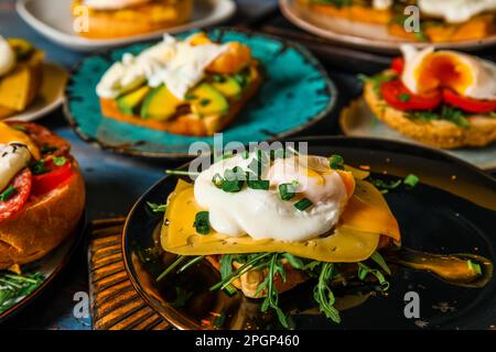 Plates with tasty eggs Benedict on table Stock Photo