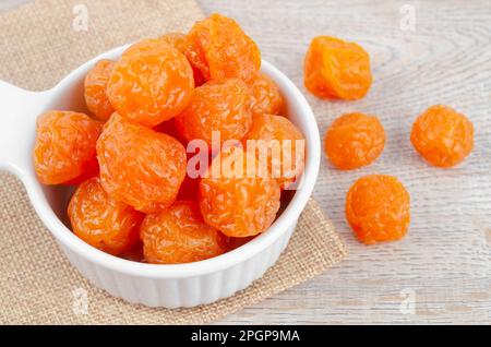 Preserved fruits or dried honey Chinese plum on wooden background Stock Photo